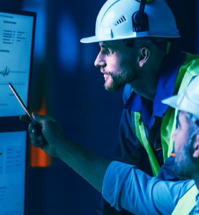 Smart factory floor with robotic arms and an AI interface enabling predictive automation and efficient production.