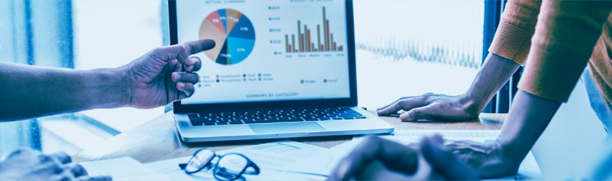 Team reviewing business data and performance metrics on a digital analytics dashboard