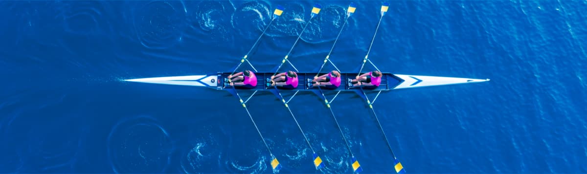 Two people shaking hands with glowing digital lines symbolizing partnership and collaboration.