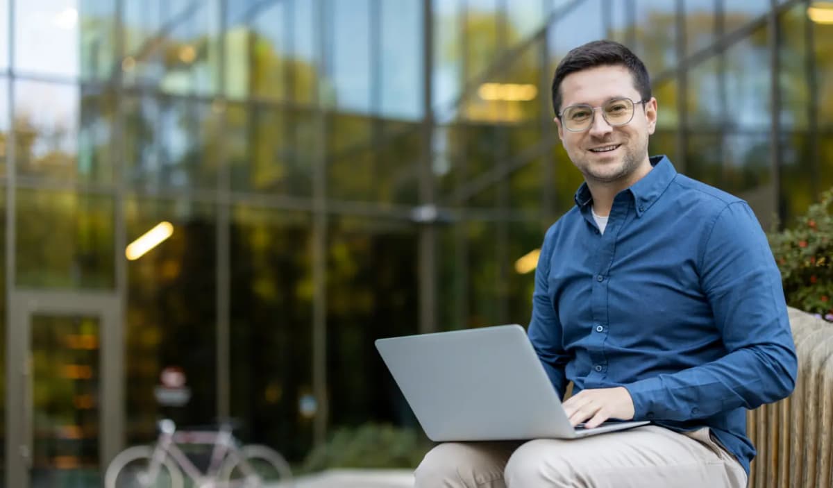 Smiling man with laptop