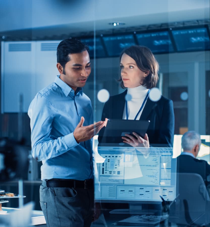 Business professionals collaborating on tablet reviewing digital data and strategies in modern corporate technology office