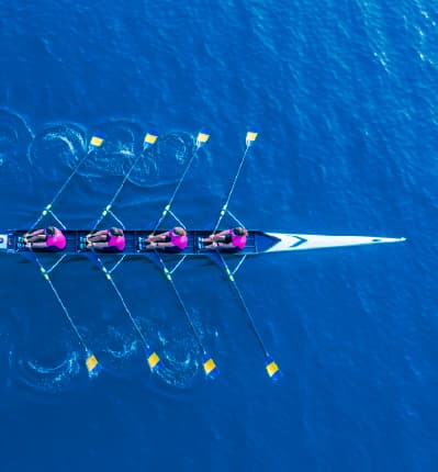 Two people shaking hands with glowing digital lines symbolizing partnership and collaboration.