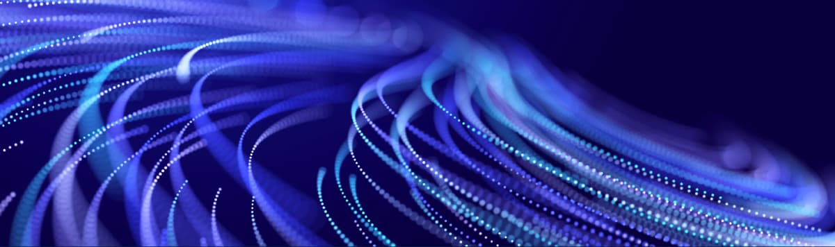Blue fiber optic cables with glowing data streams representing high-speed network connectivity and digital infrastructure
