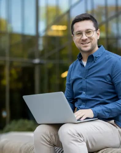 Smiling man with laptop